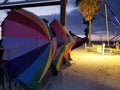Rainbow umbrellas on the beach after sunset at clearwater pier, Florida