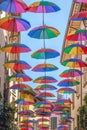 Rainbow umbrellas on blue sky background. Many colorful umbrellas, street decoration for festivals. Concept diversity Royalty Free Stock Photo