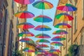 Rainbow umbrellas on blue sky background. Many colorful umbrellas, street decoration for festivals. Concept diversity Royalty Free Stock Photo