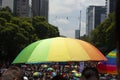 Rainbow umbrellas under the sun carried by the crowd at the LGBTTI pride march in avenue de la reforma Mexico city Royalty Free Stock Photo