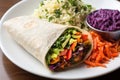 rainbow veggie burrito with a side of seasoned rice