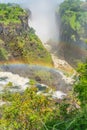 Rainbow at the Victoria Falls on Zambezi River, border of Zambia and Zimbabwe vertical Royalty Free Stock Photo