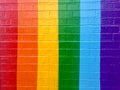 Rainbow wall painted background with copy space bright colors red orange yellow green and blue with brick texture Royalty Free Stock Photo