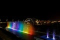 Rainbow water fountain and birdge in the night Royalty Free Stock Photo