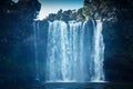 Rainbow Waterfalls in Kerikeri, New Zealand. Sunlight pours over beautiful waterfall in deep forest Royalty Free Stock Photo