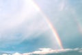 Rainbow on white cloud blue sky background after rain Royalty Free Stock Photo
