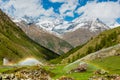 Rainbows in irrigation water spouts in Alps mountain Royalty Free Stock Photo