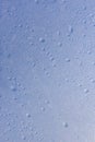 Raindrop texture on wet blue glass, closeup macro. The concept of the arrival of spring, autumn Royalty Free Stock Photo