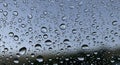 Raindrops adhere to a clear surface, likely glass, creating a beaded effect against a Royalty Free Stock Photo