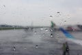 Raindrops on the airplane window at the airport