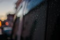 Raindrops on a black car on the side rear black window Royalty Free Stock Photo