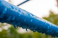 Raindrops on a blue metal pipe