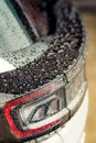 Raindrops on the car. Car element with raindrops close-up. Car rear glass with rain drops and frameless wiper blade closeup. Big Royalty Free Stock Photo