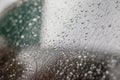 Raindrops on the car. Car element with raindrops close-up. Doors and door handle and glass of a black car in raindrops. Big Royalty Free Stock Photo