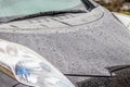 Raindrops on the car. Car element with raindrops close-up. The hood, mirror and glass of a black car covered in raindrops. Big Royalty Free Stock Photo