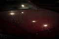 Raindrops on car in dark. Car at night in parking lot. Car in rain Royalty Free Stock Photo