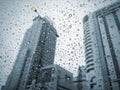 Raindrops on car glass at city in rainy day Royalty Free Stock Photo