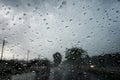 Raindrops on the car glass while driving through heavy rain and storm surges Royalty Free Stock Photo