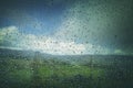 Raindrops on Car Window with Blurry Landscape in Background Royalty Free Stock Photo