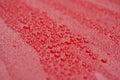 Raindrops on ceramic coated red car with hydrophobic effect