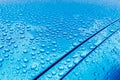 Raindrops on a turquoise car body with Hydrophobic Effect