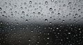 Raindrops cover a glass surface, with varying sizes creating a textured pattern. The Royalty Free Stock Photo