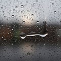Raindrops cover a glass window creating a textured pattern across the surface Royalty Free Stock Photo