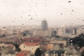 Raindrops on the dirty glass, behind the glass blurred panorama