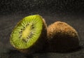 Raindrops falling over fresh slices of kiwi Royalty Free Stock Photo