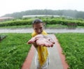 Raindrops falling on a woman`s palm