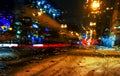 Rain drops on car window with road light bokeh, City life in night in rainy season abstract background,water drop on