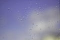 Raindrops on glass and blue morning sky Royalty Free Stock Photo