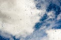 Raindrops on glass with blue sky in the background Royalty Free Stock Photo