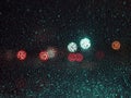 Raindrops on the glass on blur background of colored spots