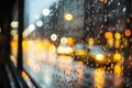 raindrops on a glass with blurred background of wet autumn city street, road and cars, streetlights in the evening, late Royalty Free Stock Photo