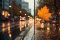 raindrops on a glass with blurred background of wet autumn city street, road and cars, streetlights in the evening, late Royalty Free Stock Photo