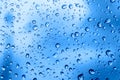 Raindrops on glass. Bright beautiful background of trendy blue color. Delicate classic backdrop. Water drop texture. Royalty Free Stock Photo