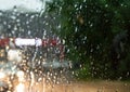 Raindrops on glass, sign and headlights of the car.selective Royalty Free Stock Photo