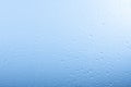 Raindrops on glass window over grey and blue sky Royalty Free Stock Photo
