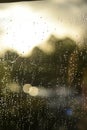 Raindrops glisten on a sunlit windowpane, softly reflecting the light Royalty Free Stock Photo