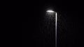 Raindrops illuminated by street lamp during heavy thunderstorm at night