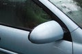 Raindrops on a mirror and windows of metallic blue car after rain Royalty Free Stock Photo