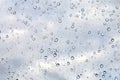 Raindrops on misted window glass against a blue sky Royalty Free Stock Photo