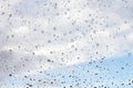 Raindrops on misted window glass against a blue sky Royalty Free Stock Photo