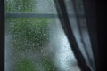 Raindrops on a mosquito net. Mosquito net on a window with a curtain. Horizontal photo, macro Royalty Free Stock Photo