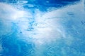 Raindrops on pool blue water surface. blue water texture as background. Stains circles on the water from rain
