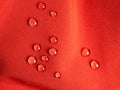 Raindrops on red sports waterproof fabric