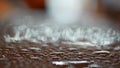 Raindrops on the roof of a car. Close-up of droplets in the evening. Focus moves