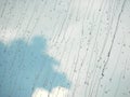 Raindrops running on glass with blue sky and white cloud Royalty Free Stock Photo