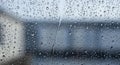 Raindrops are scattered across a glass window, creating a textured pattern. The Royalty Free Stock Photo